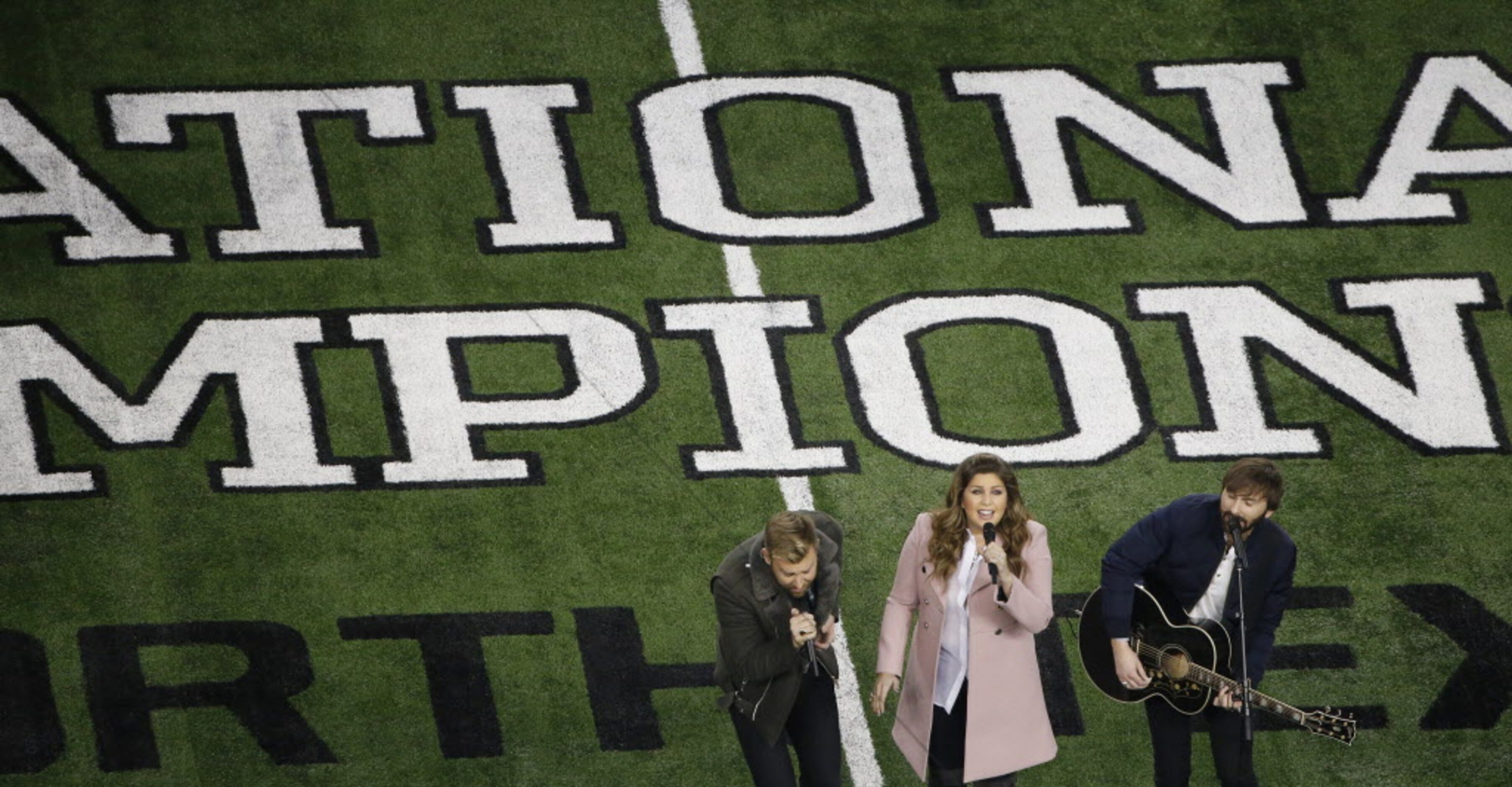 Lady Antebellum performs the United State National Anthem before the College Football...