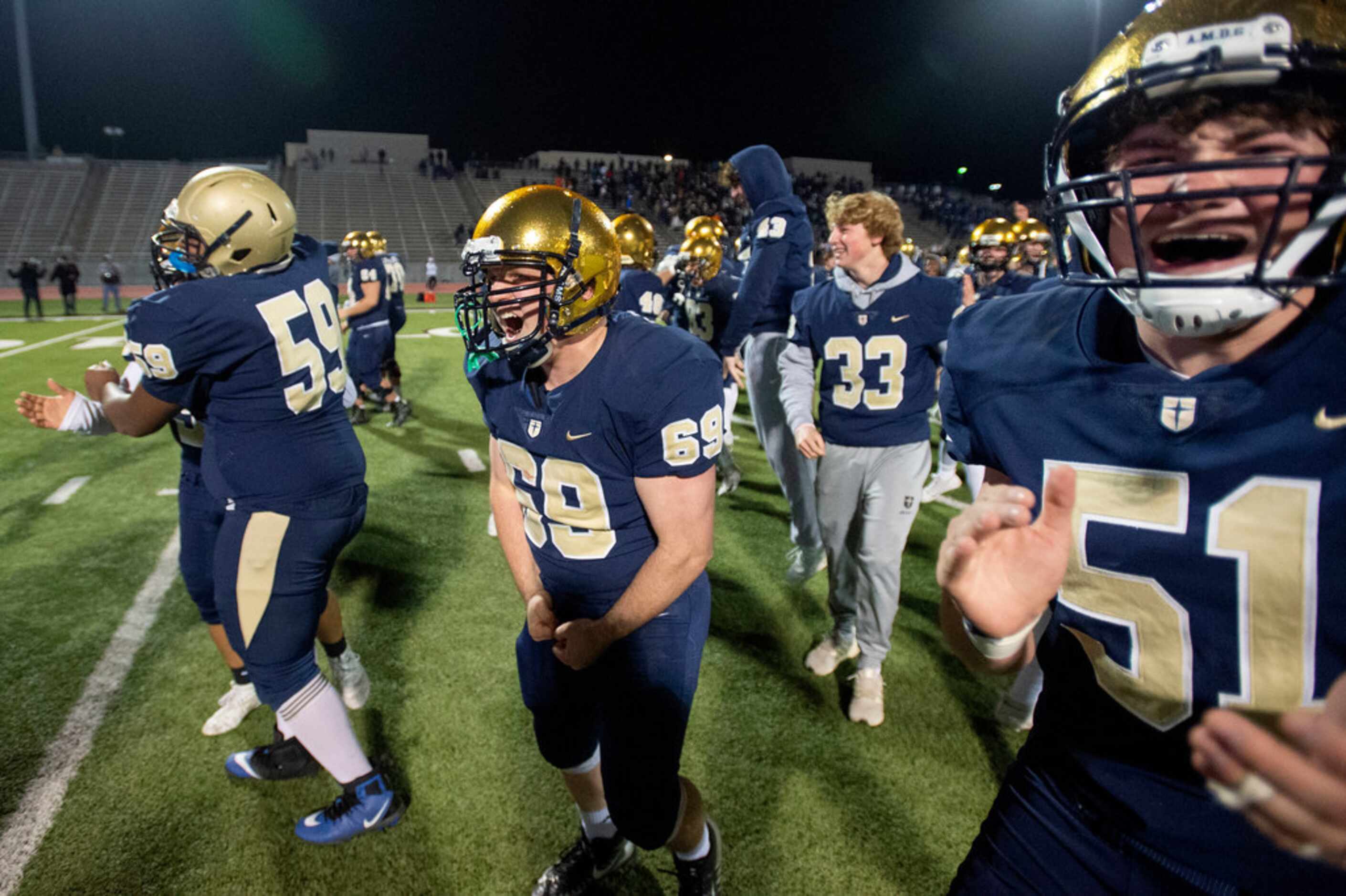 Jesuit players celebrate their 27-25 victory over defending state champions Longview in an...