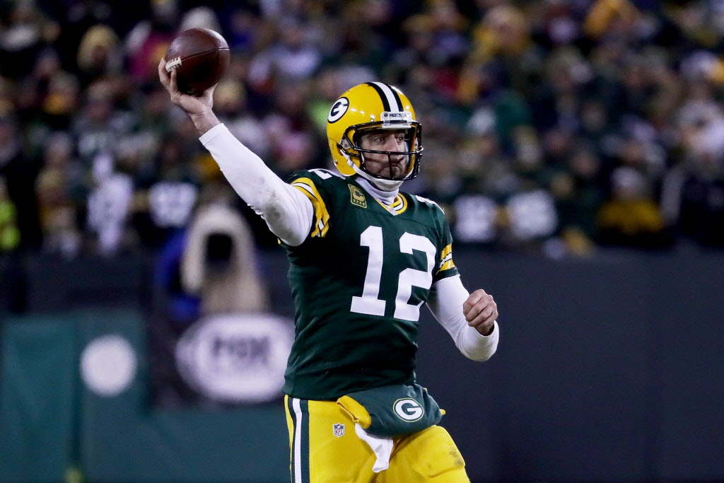 GREEN BAY, WI - JANUARY 8:  Aaron Rodgers #12 of the Green Bay Packers throws a pass in the...