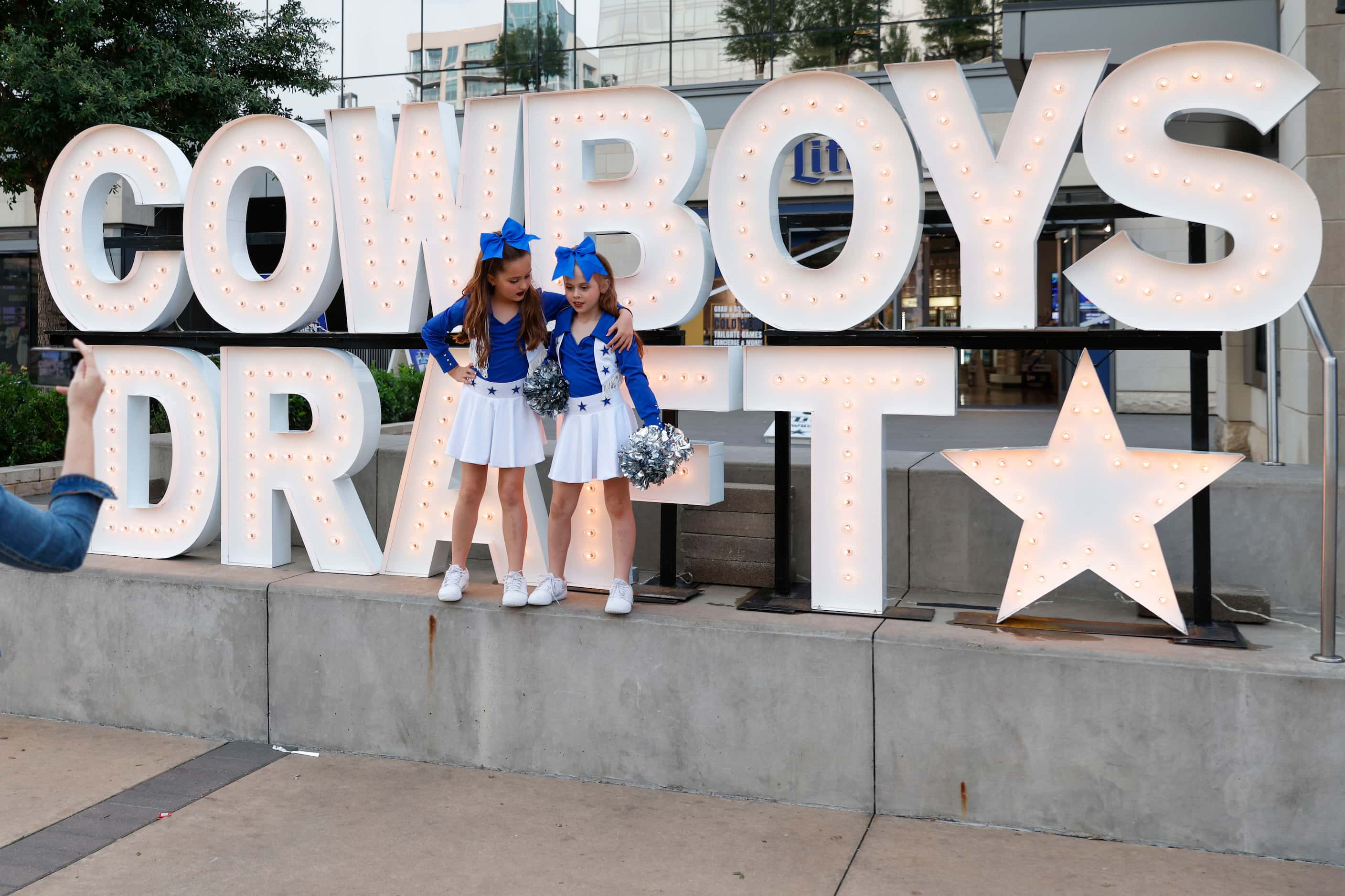 Amelia Purdue, 9, (left) with her friend Hannah Paulek, 9, pose for a photo, wearing Dallas...