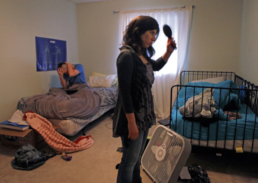 Elise Jones (right) gets ready for the day in her room at the Goodman House in Plano as...