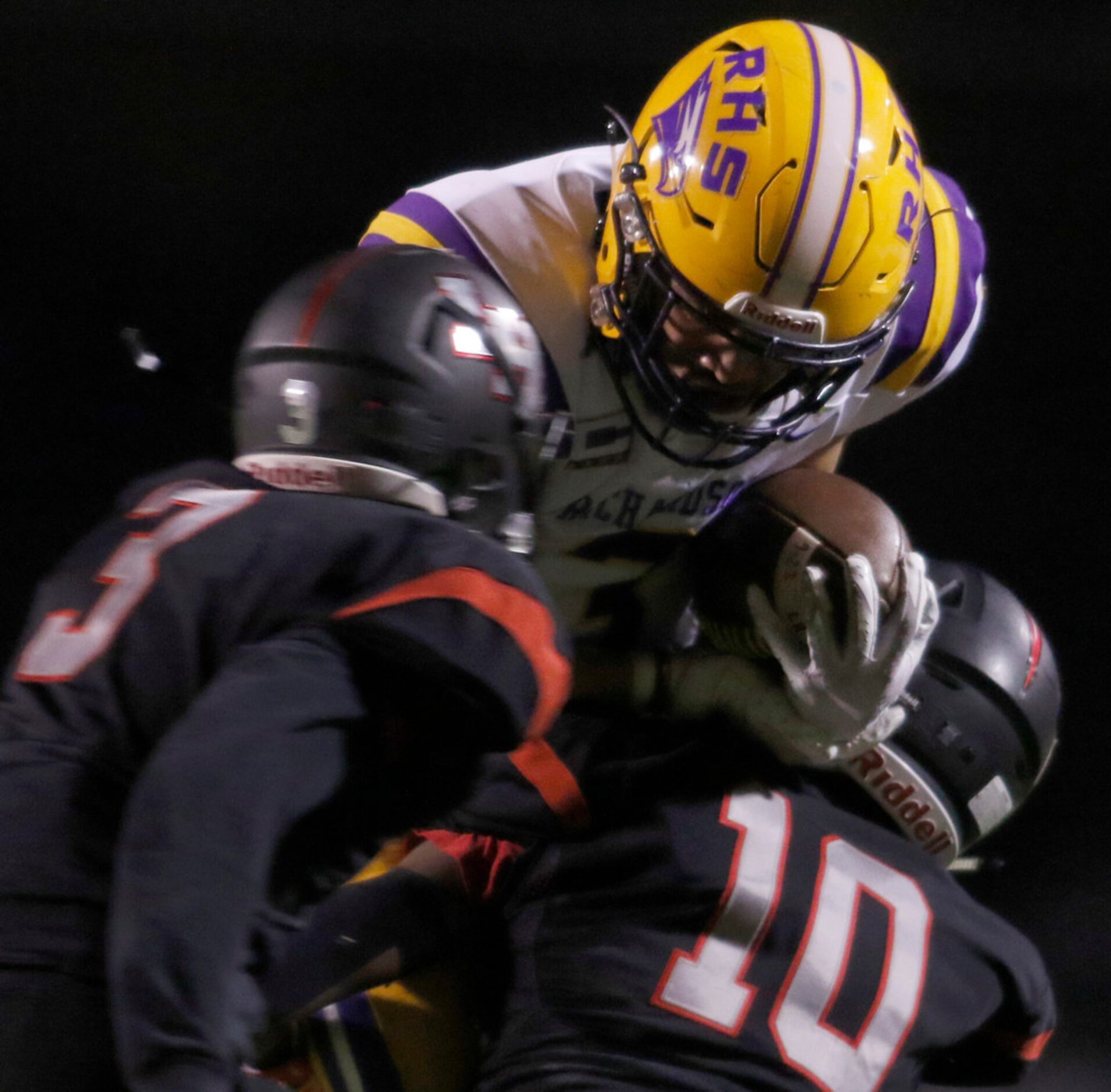 Richardson receiver Sam Berry (3) is tackled by Lake Highlands defenders Jeremiah Richards...