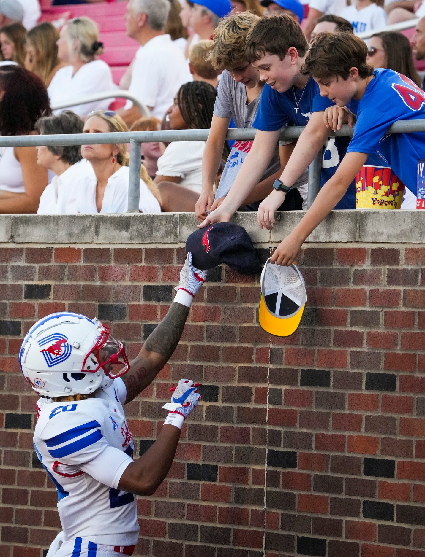 SMU wide receiver Jayleen Record signs autographs during the first half of an NCAA football...