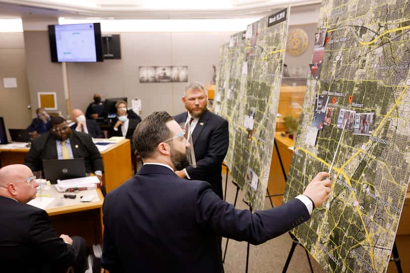 Prosecutor Dimitri Anagnostis (center) points to locations on a large map where FBI special...