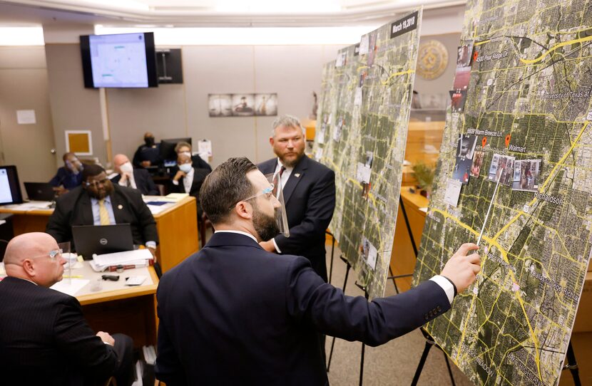 Prosecutor Dimitri Anagnostis (center) points to locations on a large map where FBI special...