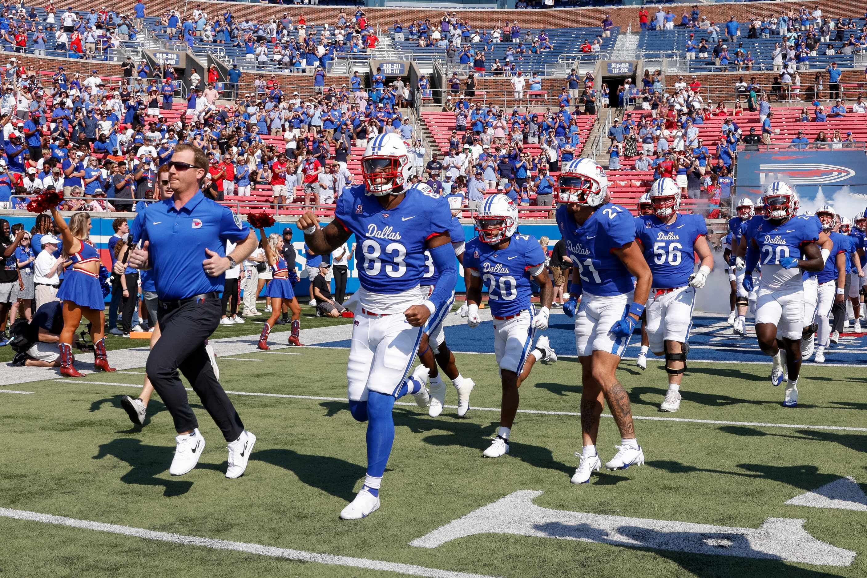 SMU head coach Rhett Lashlee leads the team onto the field before a game against TCU at Ford...