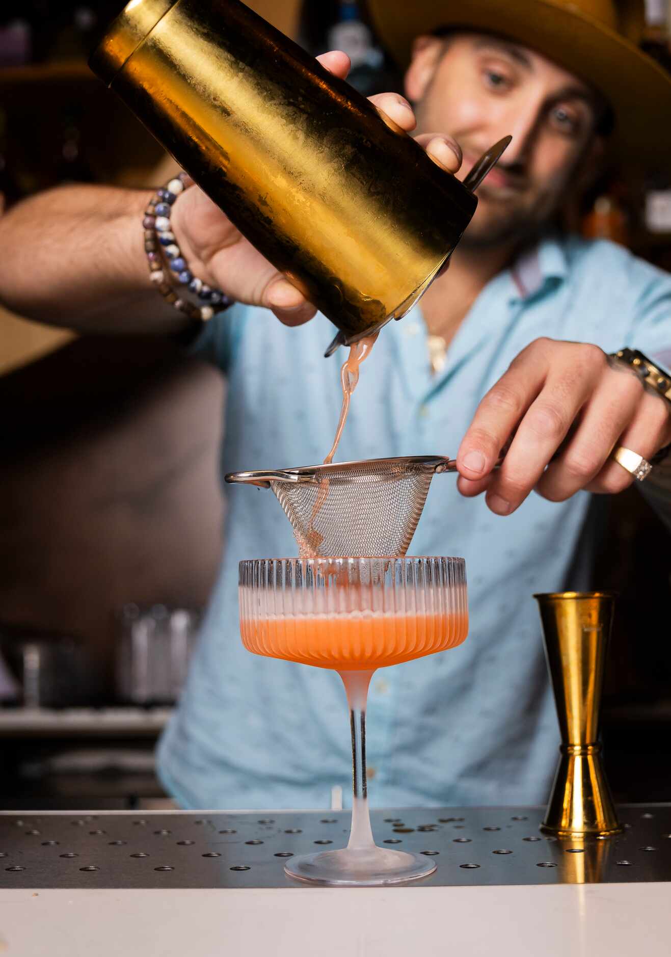 Owner Ryan Oruch prepares a Bubblz & Berriez cocktail with strawberry infused vodka, lemon,...