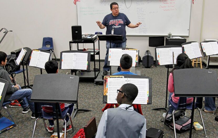 
Abulusine “Lee” Kamara (center bottom) participates in his band class, with band teacher...