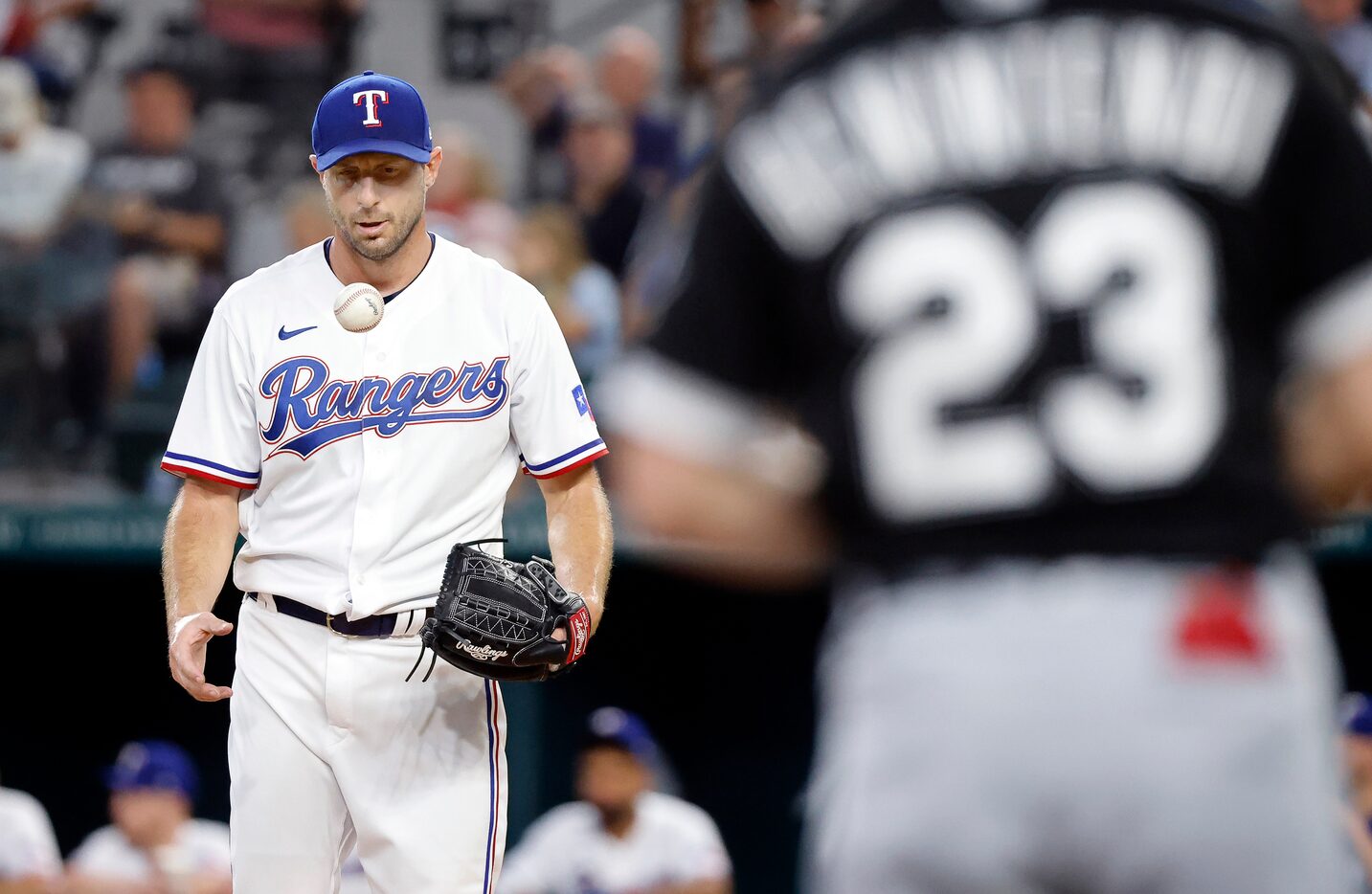 Texas Rangers starting pitcher Max Scherzer (31) flips the ball to his throwing hand as he...