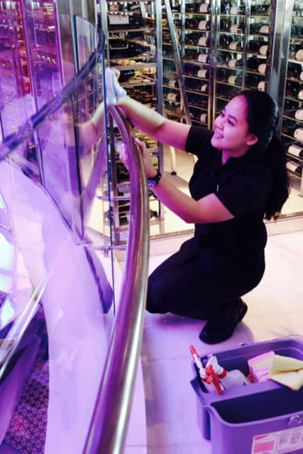 Yulia Asriyani cleans glass in the ship's atrium. She worked in a hotel in her native...