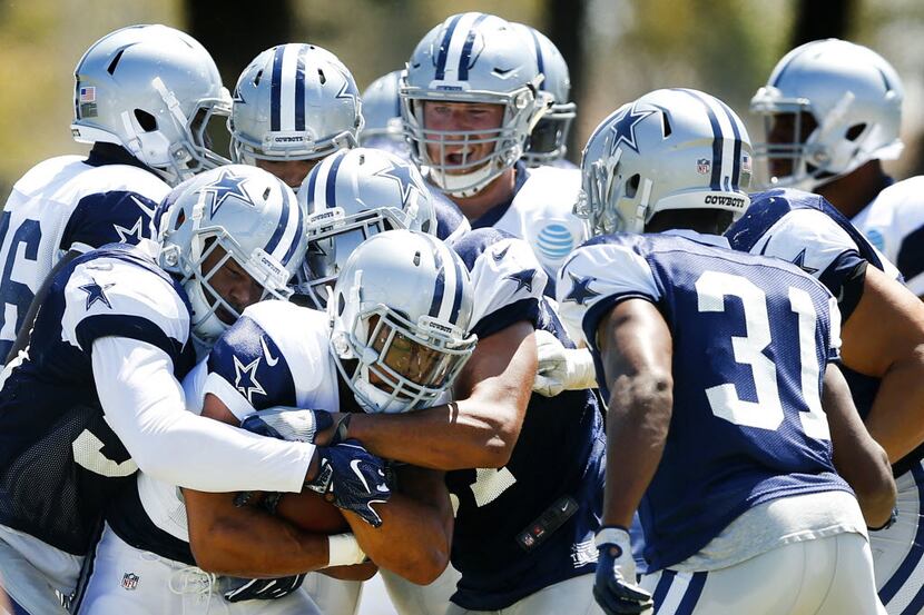 Dallas Cowboys running back Darius Jackson (34) is gang tackled by the defense as he carries...