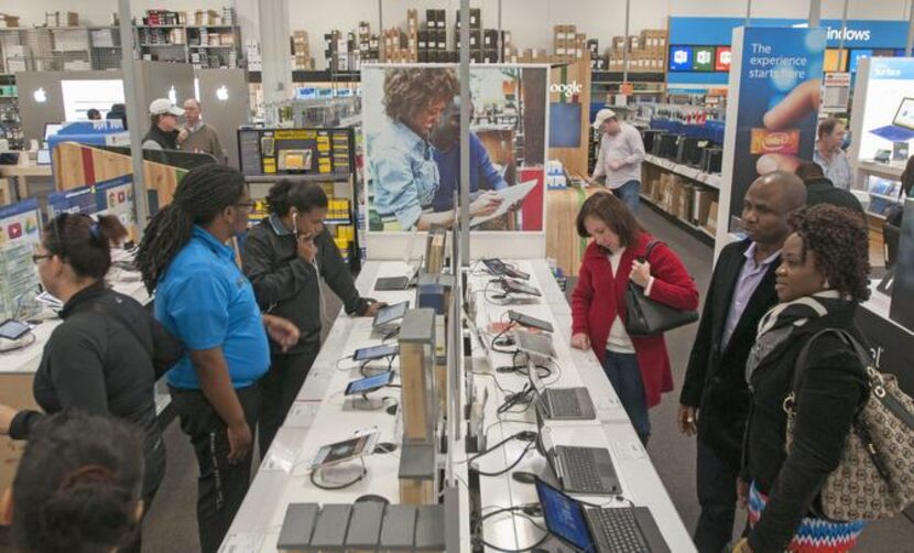 
Customers shop for tablets at Best Buy in northeast Dallas. Last year, more than 100...