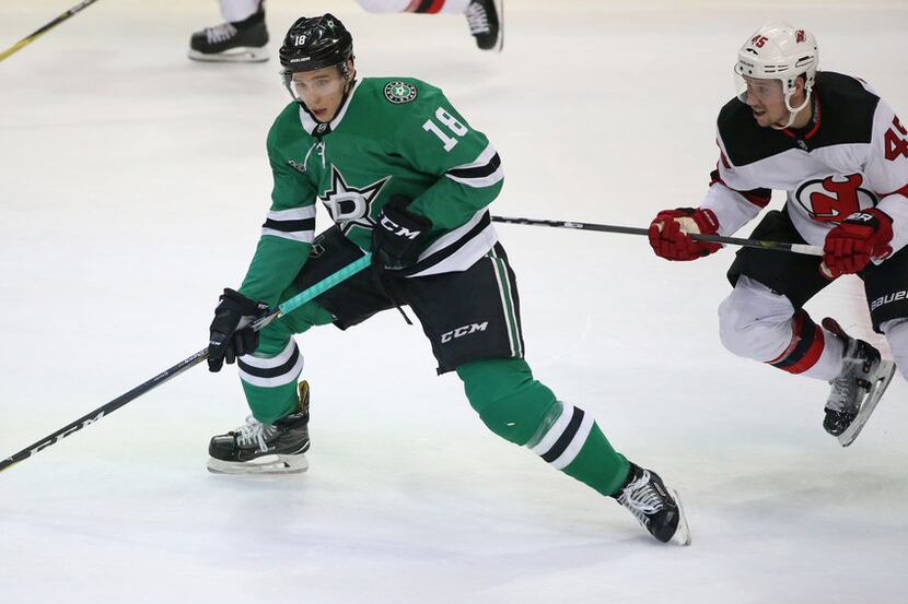 Dallas Stars center Tyler Pitlick (18) skates with the puck as New Jersey Devils defenseman...