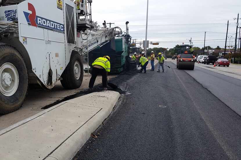 Crews in Plano are seen in June working on one of several overlay pavement projects in the...