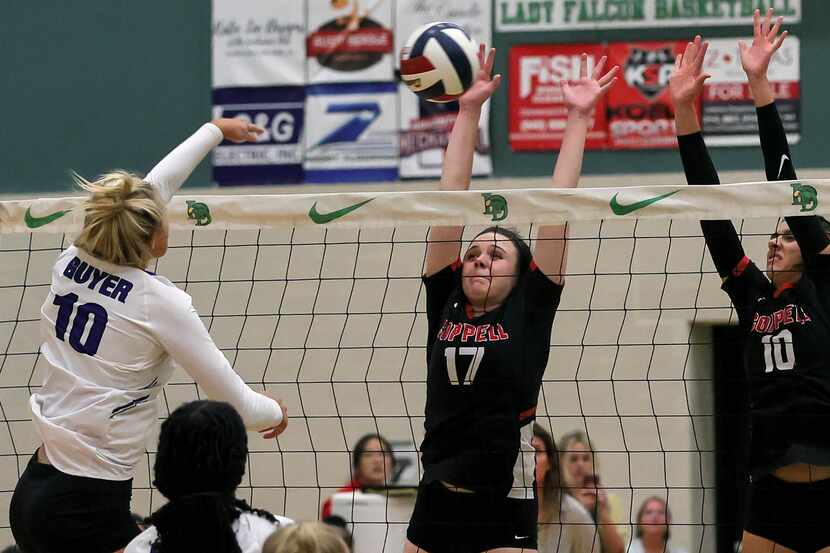 Denton Guyer's Madalynn Hokanson (10) tries for a kill against Coppell's Taylor Young (17)...