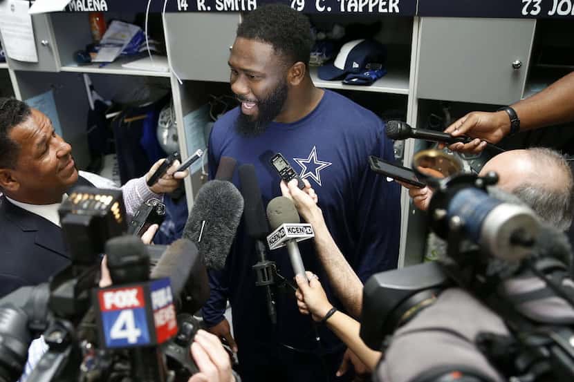 Cowboys rookie defensive end Charles Tapper talks with the media in a locker room during the...