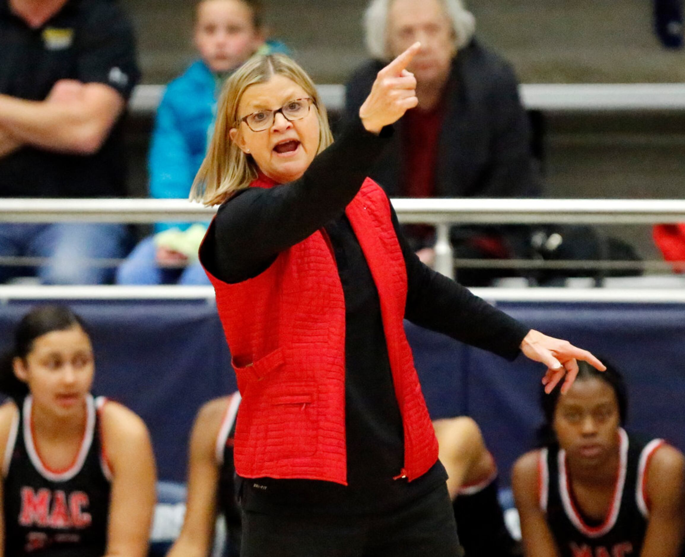 Irving MacArthur High School head coach Suzie Oelschlegel gives instruction to her team near...