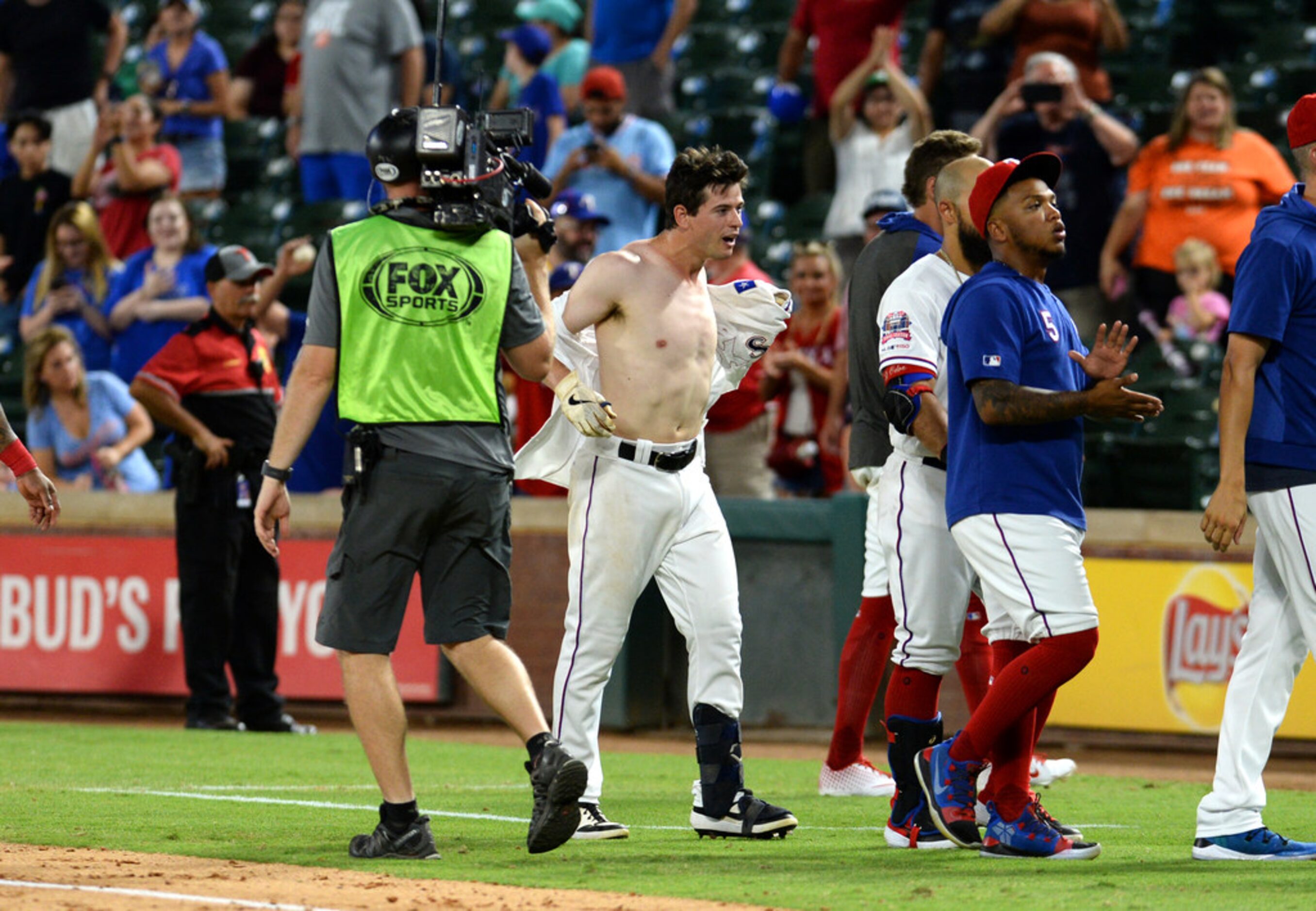 ARLINGTON, TEXAS - AUGUST 20: Nick Solak #15 of the Texas Rangers celebrates with his...