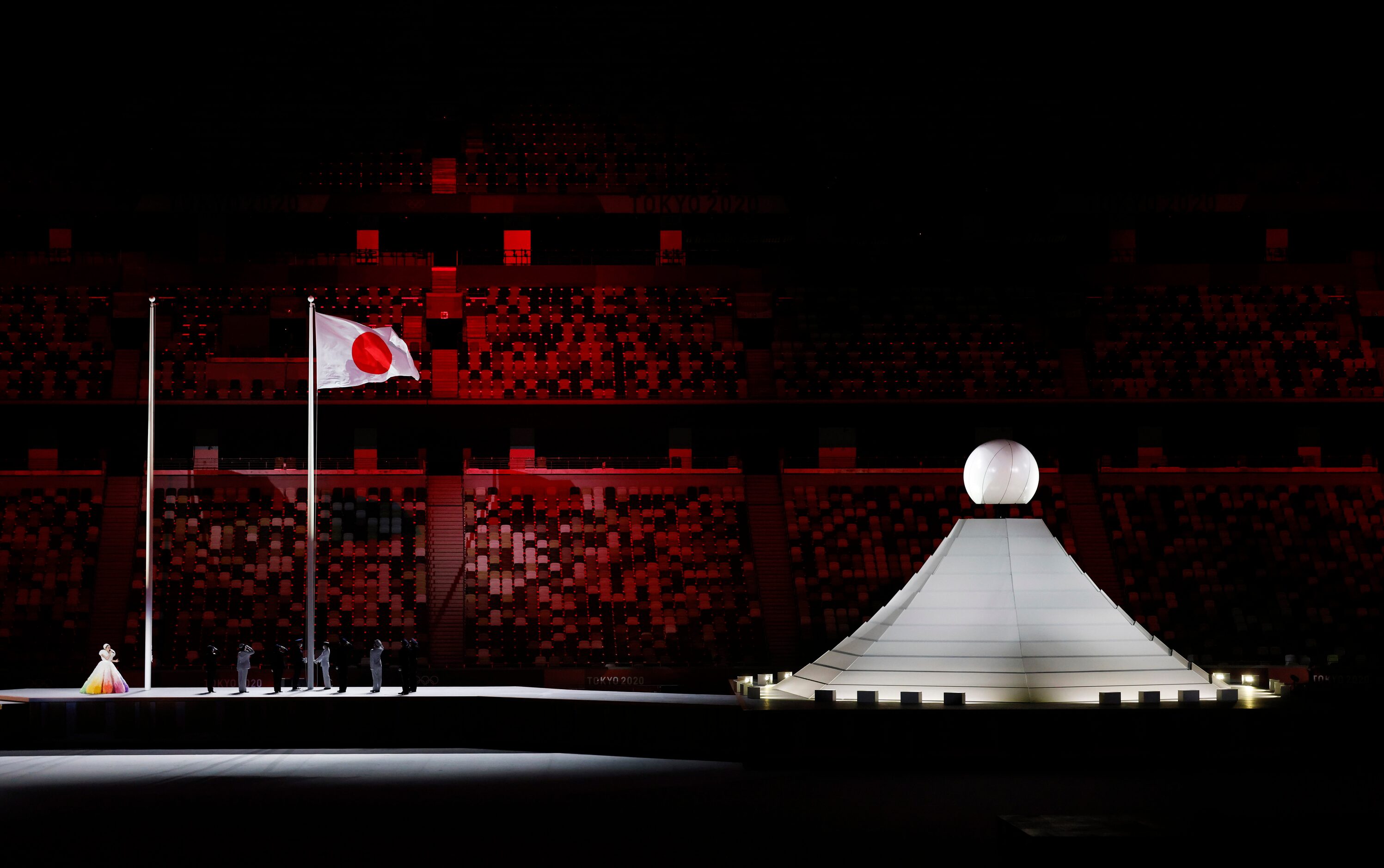 The flag for Japan is raised during the opening ceremony for the postponed 2020 Tokyo...