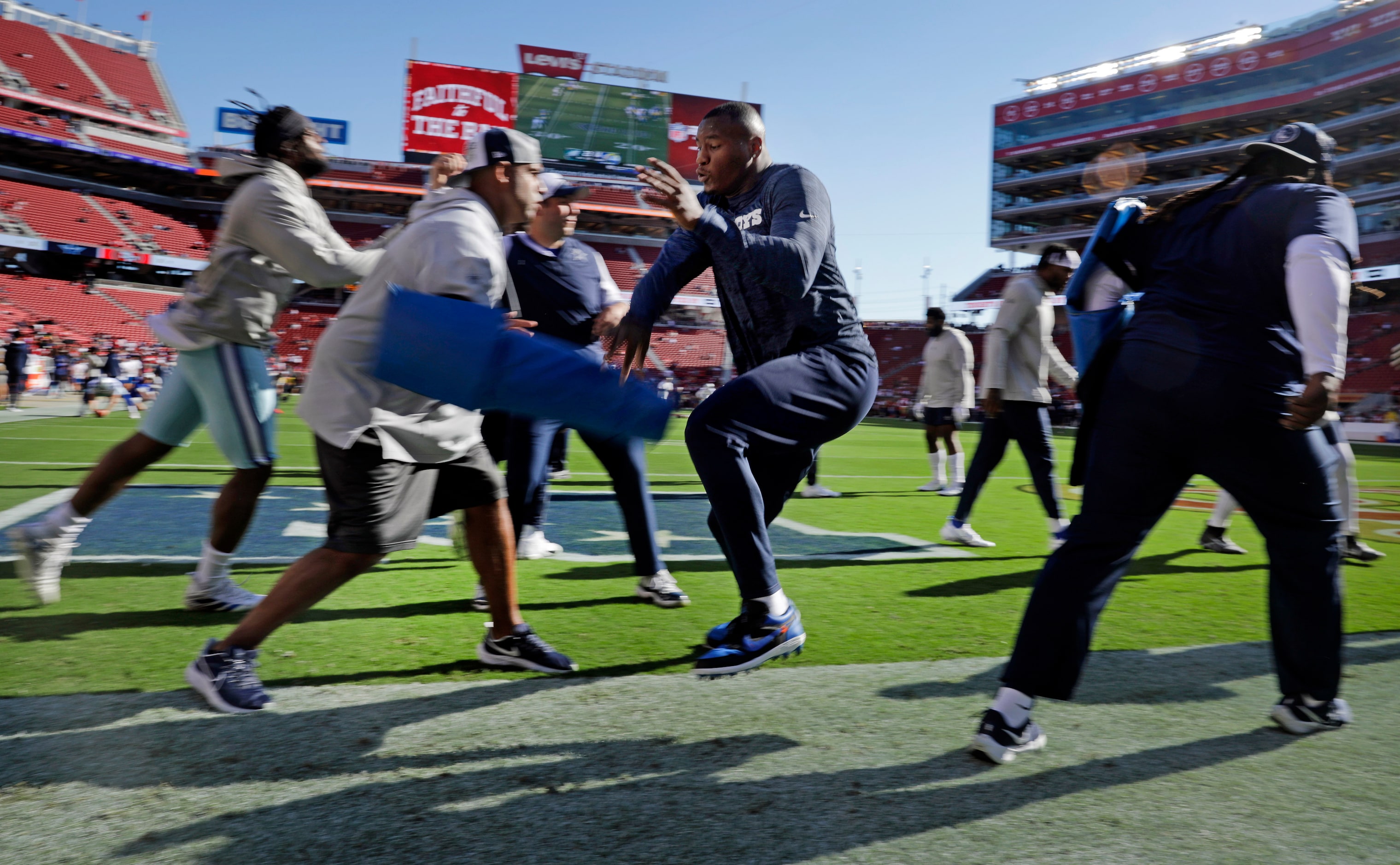 The Dallas Cowboys defensive lineman runs through drills during pregame warmups before...