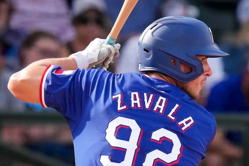 Texas Rangers outfielder Aaron Zavala bats during a spring training game against the Kansas...