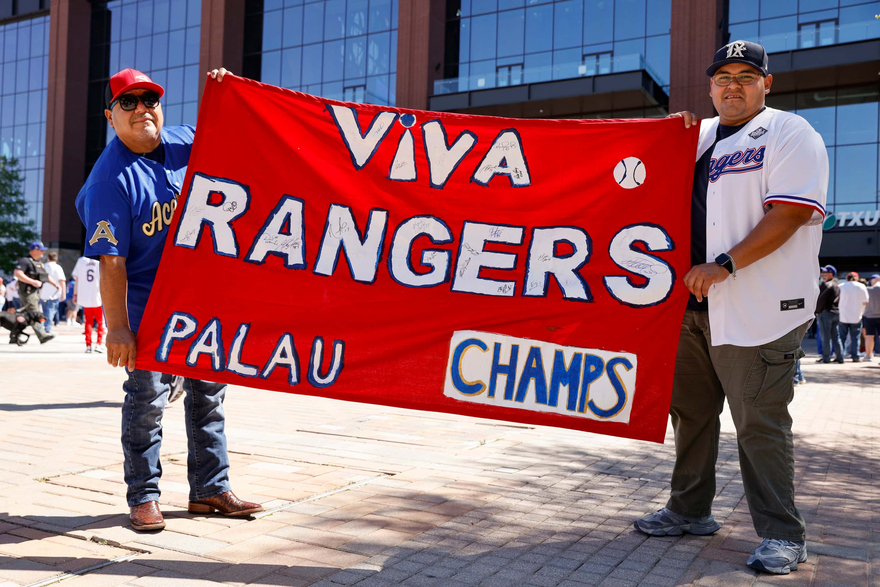 Luis Campos Sr. (left) holds a banner he made with his son Luis Campos Jr. before the Texas...