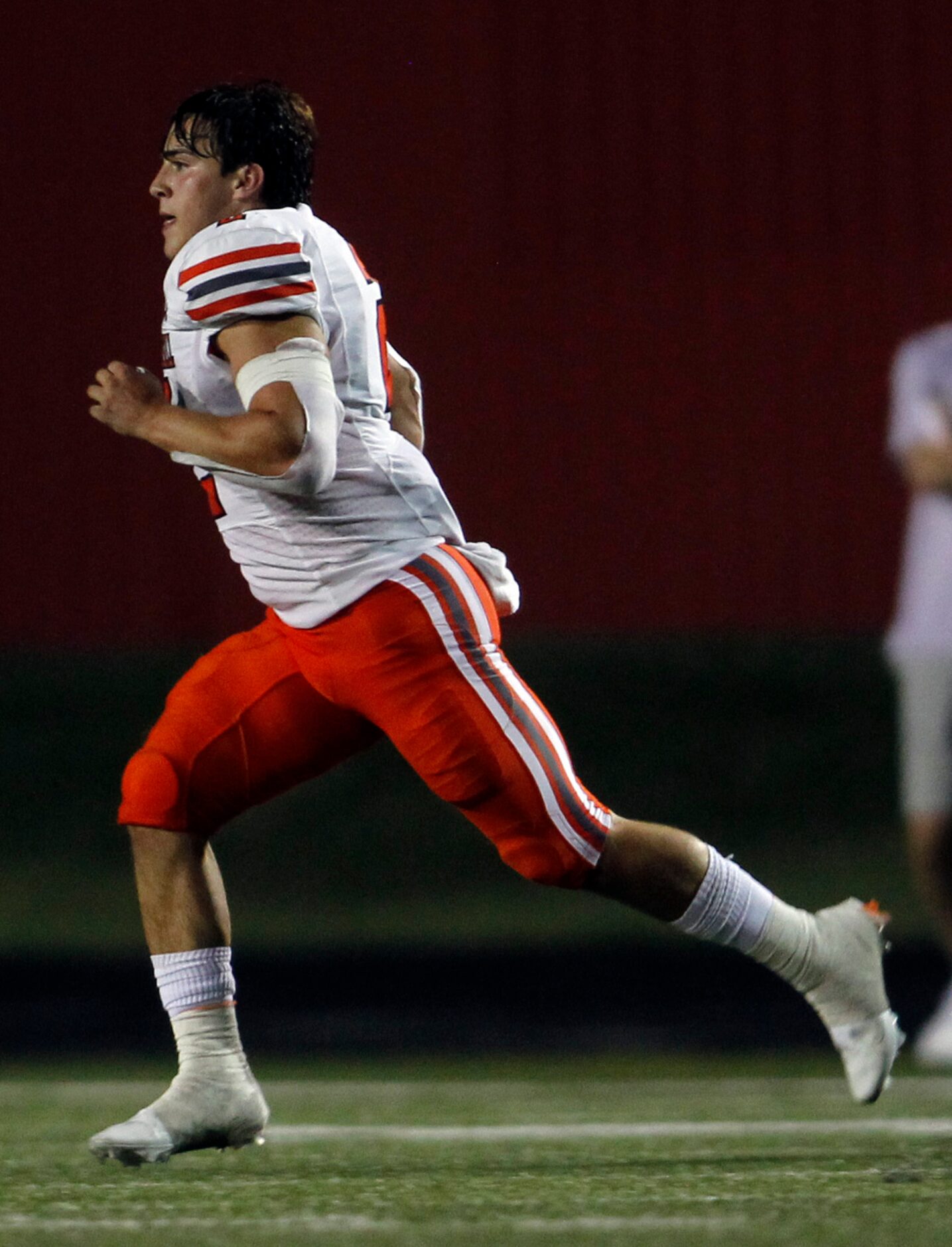 Rockwall running back Zach Hernandez (2) sprints across the field to retrieve his helmet...