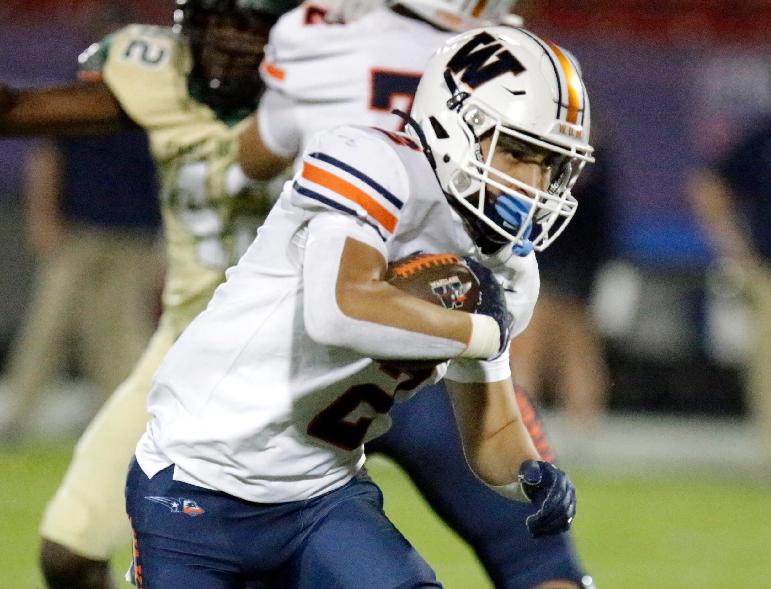 Wakealnd High School running back Ivan Molina (2) carries the football during the first half...