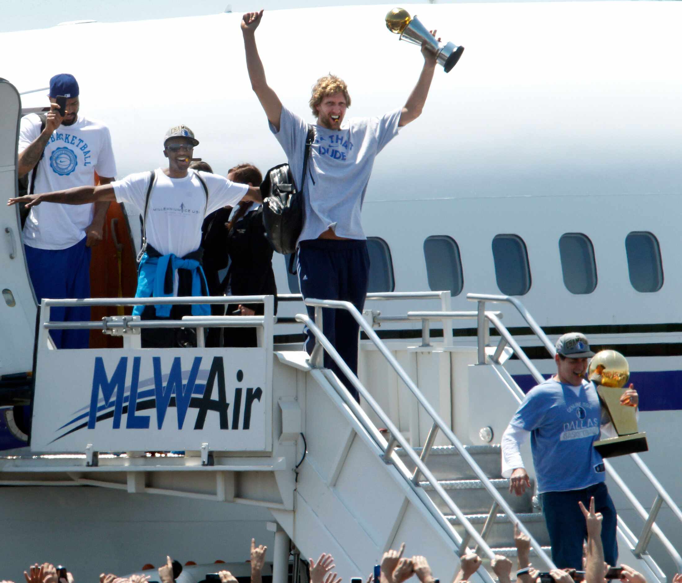Dallas Mavericks owner Mark Cuban (lower right) held the Larry O'Brien NBA Championship...