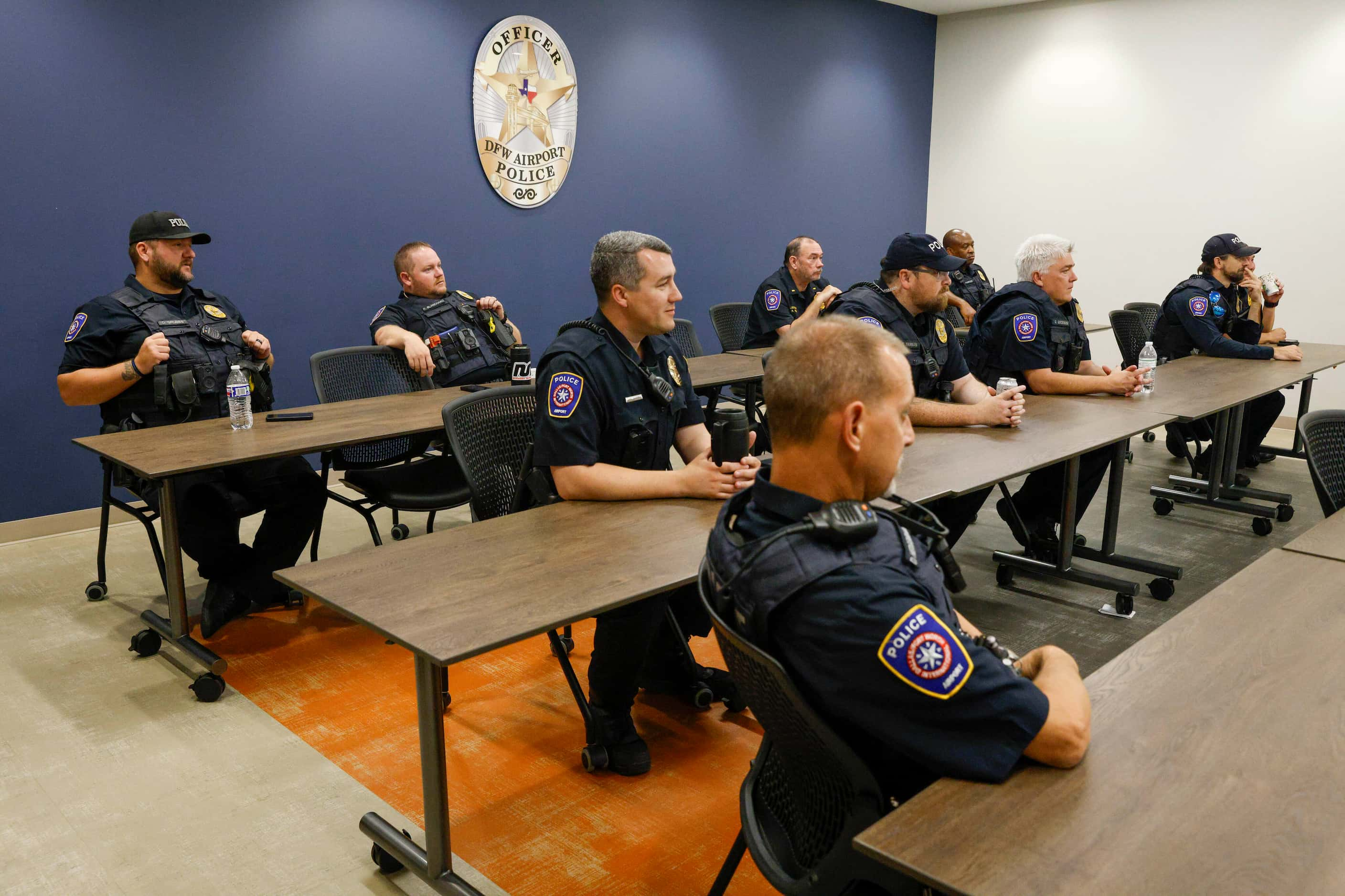 DFW Airport police officers gather for a briefing before heading out for start of their 12...