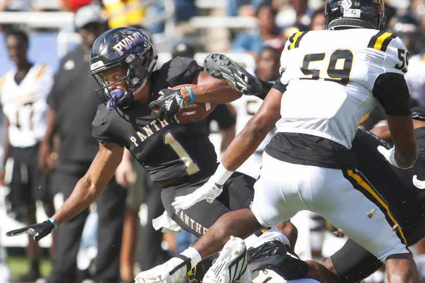 Prairie View running back Dawonya Tucker (1) spins for extra yardage against the Grambling...