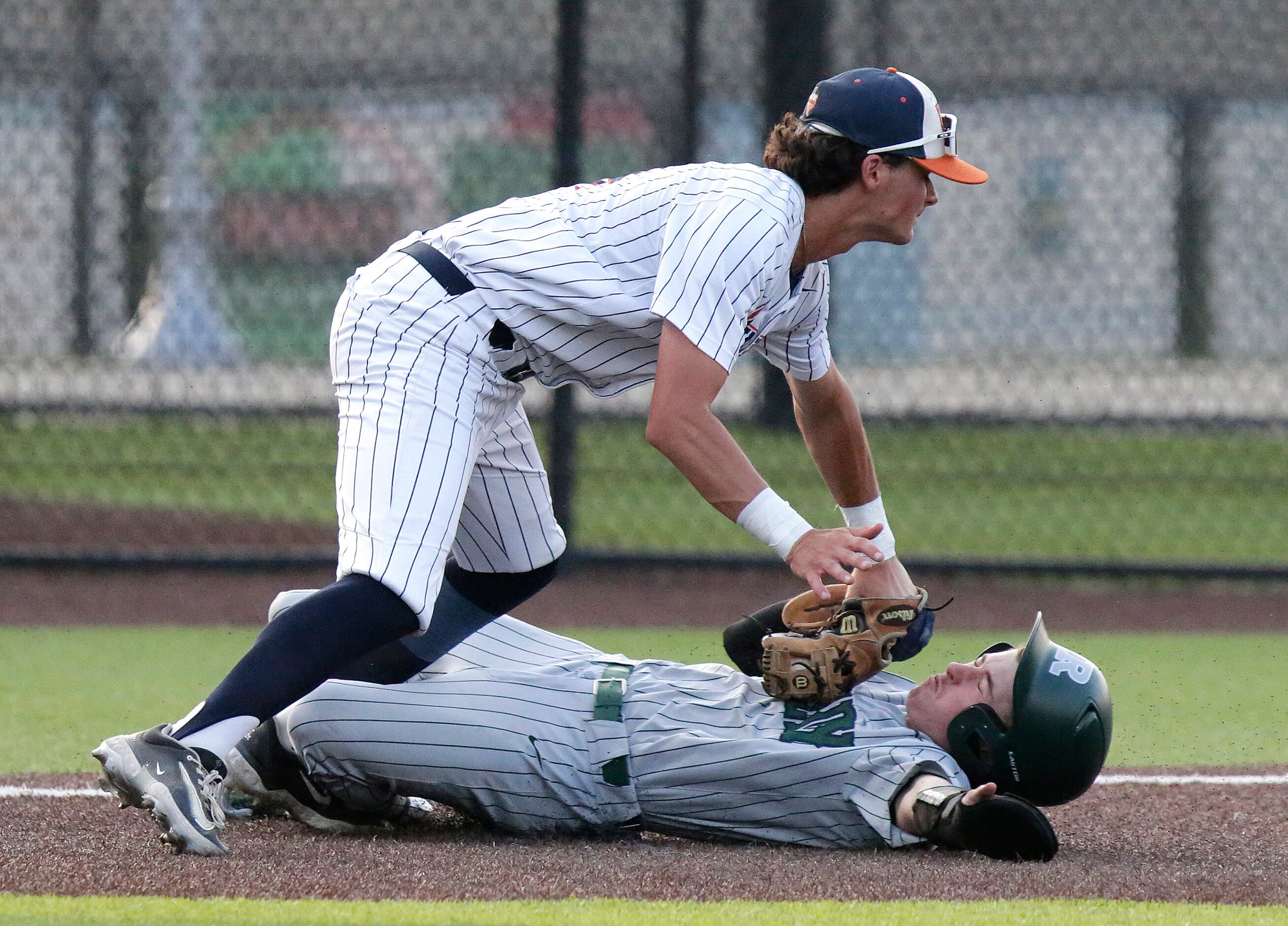 Wakeland High School third baseman Owen Cassano (4) gets the tag at third for the out on...