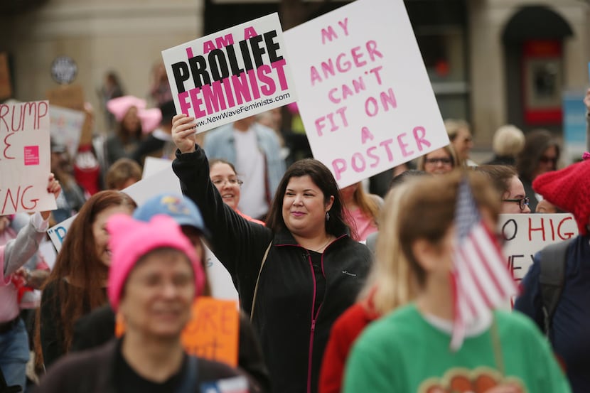 Rachel Lamb, of Richardson, who is part of the group New Wave Feminists, marchers in the...