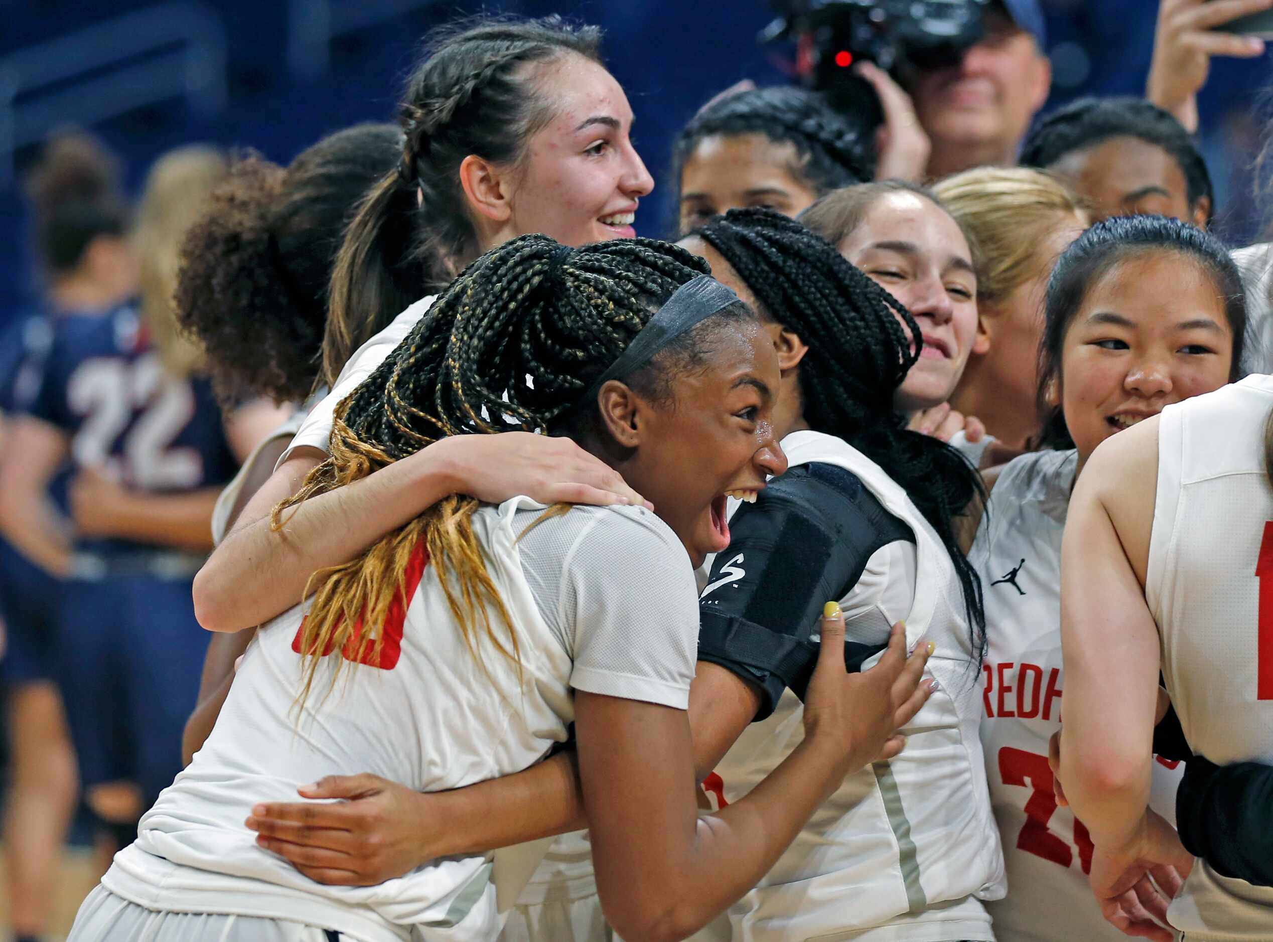 Frisco Liberty guard Jazzy Owens-Barnet #30 joins the rest of the team in celebrating at the...