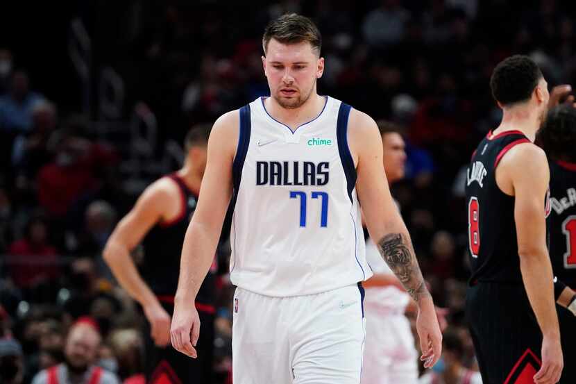 Dallas Mavericks guard Luka Doncic looks down as he walks on the court during the first half...