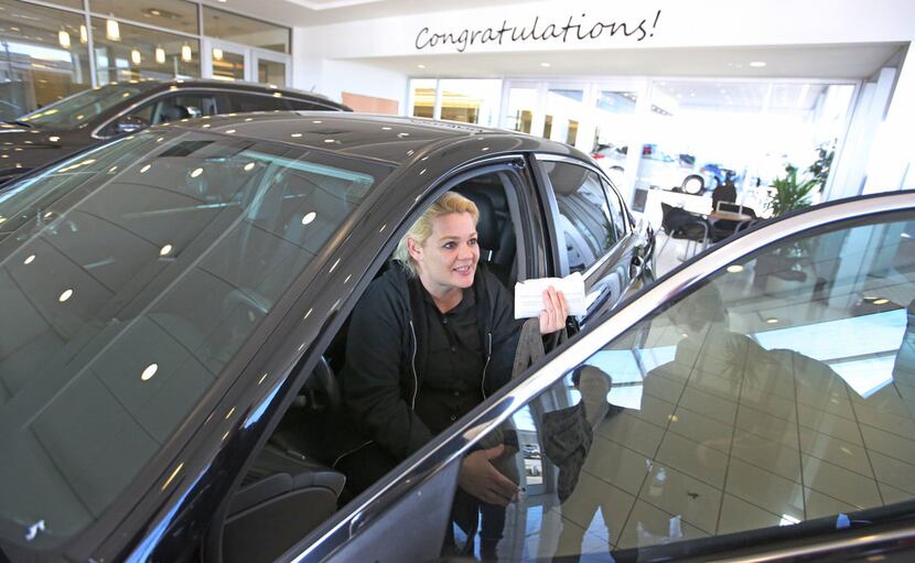 Christal Scott reacts to receiving a 2012 Honda Accord in a ceremony at Ewing Buick...