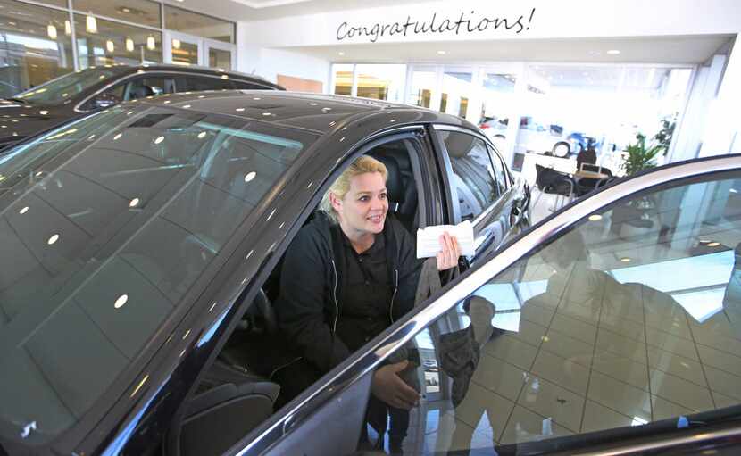Christal Scott reacts to receiving a 2012 Honda Accord in a ceremony at Ewing Buick...