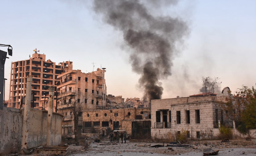  Smoke billows in Aleppo's Bustan al-Basha neighbourhood on November 28, 2016, during Syrian...