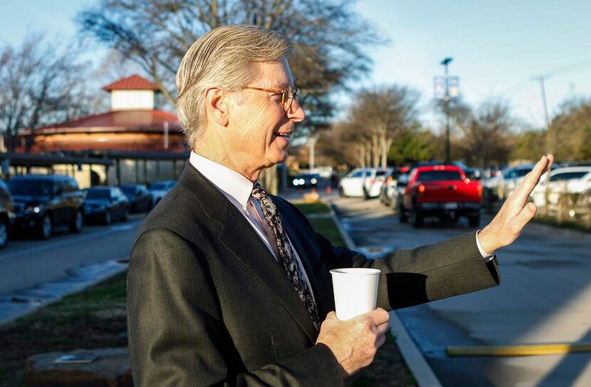 
Head of School Walter Sorenson waves as parents arrive with their children for the morning...