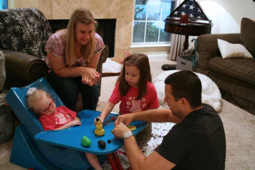 The members of the Howard family, of Carrollton, play together on Labor Day. Harper (left)...