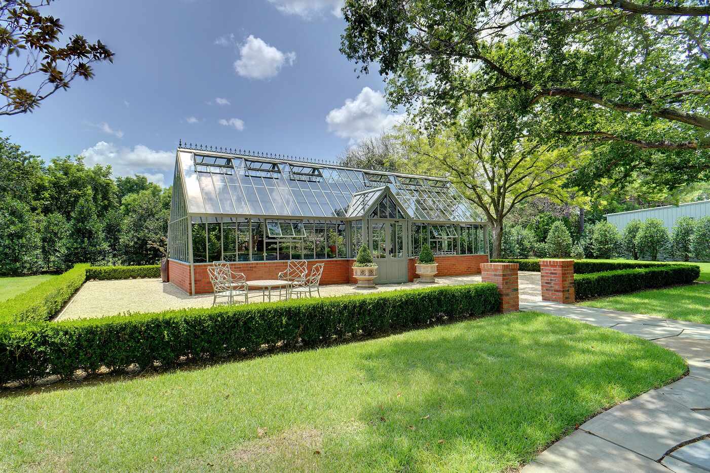 The classically-styled greenhouse on the property at 6401 Westcoat Drive in Colleyville has...