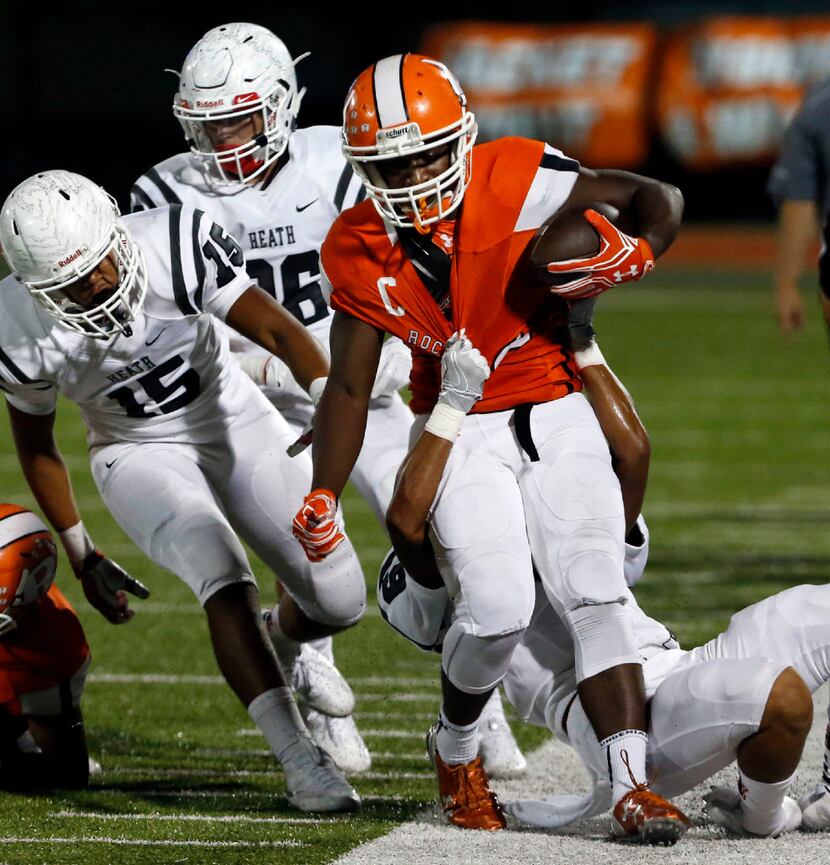 Rockwall High's AJ Blacknall (22) is tackled by Heath High's Kendell Jimerson (6) during the...