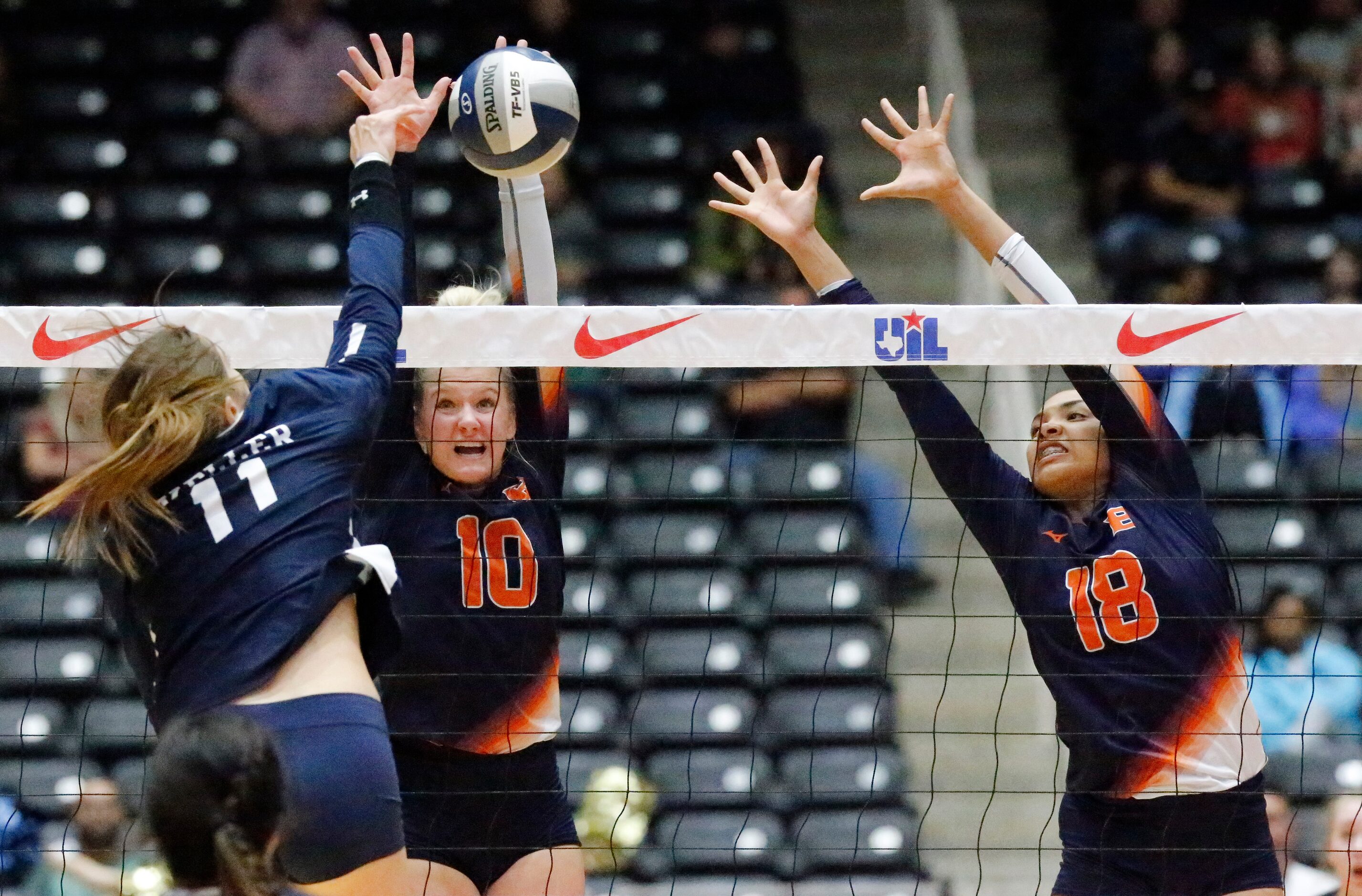 Northside Brandeis middle Carlee Pharris (10) and outside hitter Austin Smoak (18) attempt...