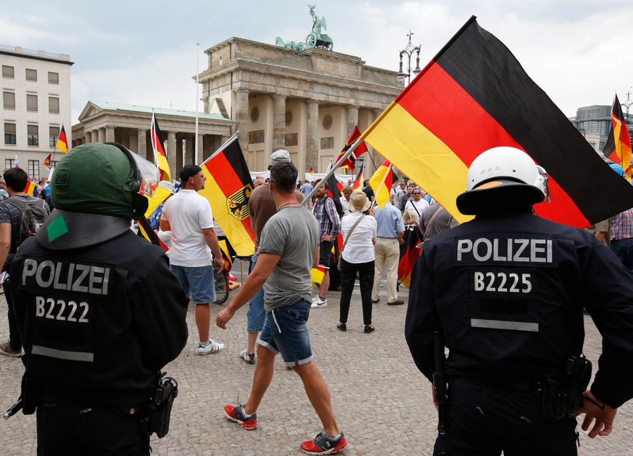 Supporters of German AfD wave flags in front of the Brandenburg Gate in Berlin, Germany,...