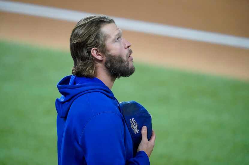 Los Angeles Dodgers starting pitcher Clayton Kershaw stands for the national anthem before ...