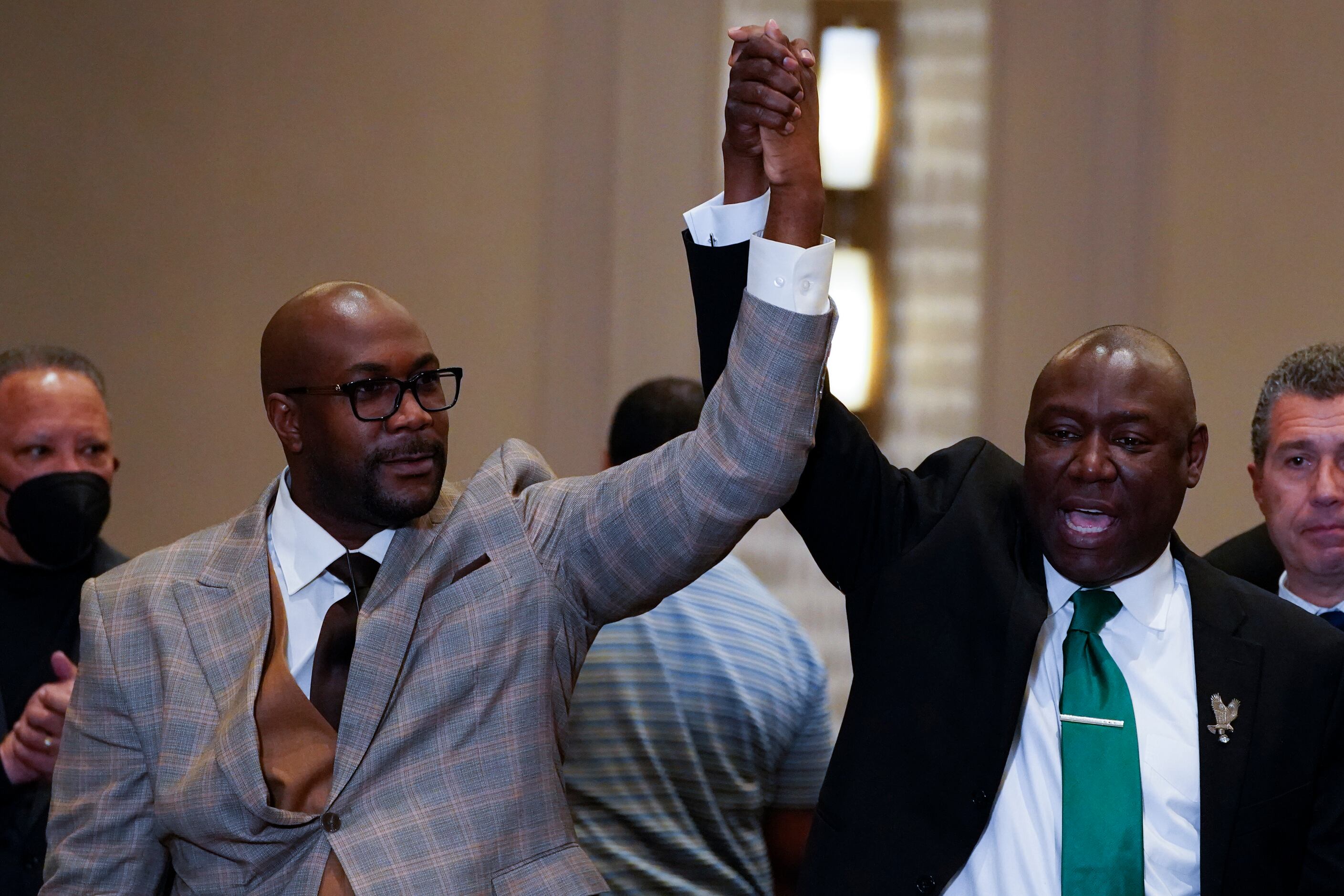 Philonise Floyd and Attorney Ben Crump, from left, react after a guilty verdict was...