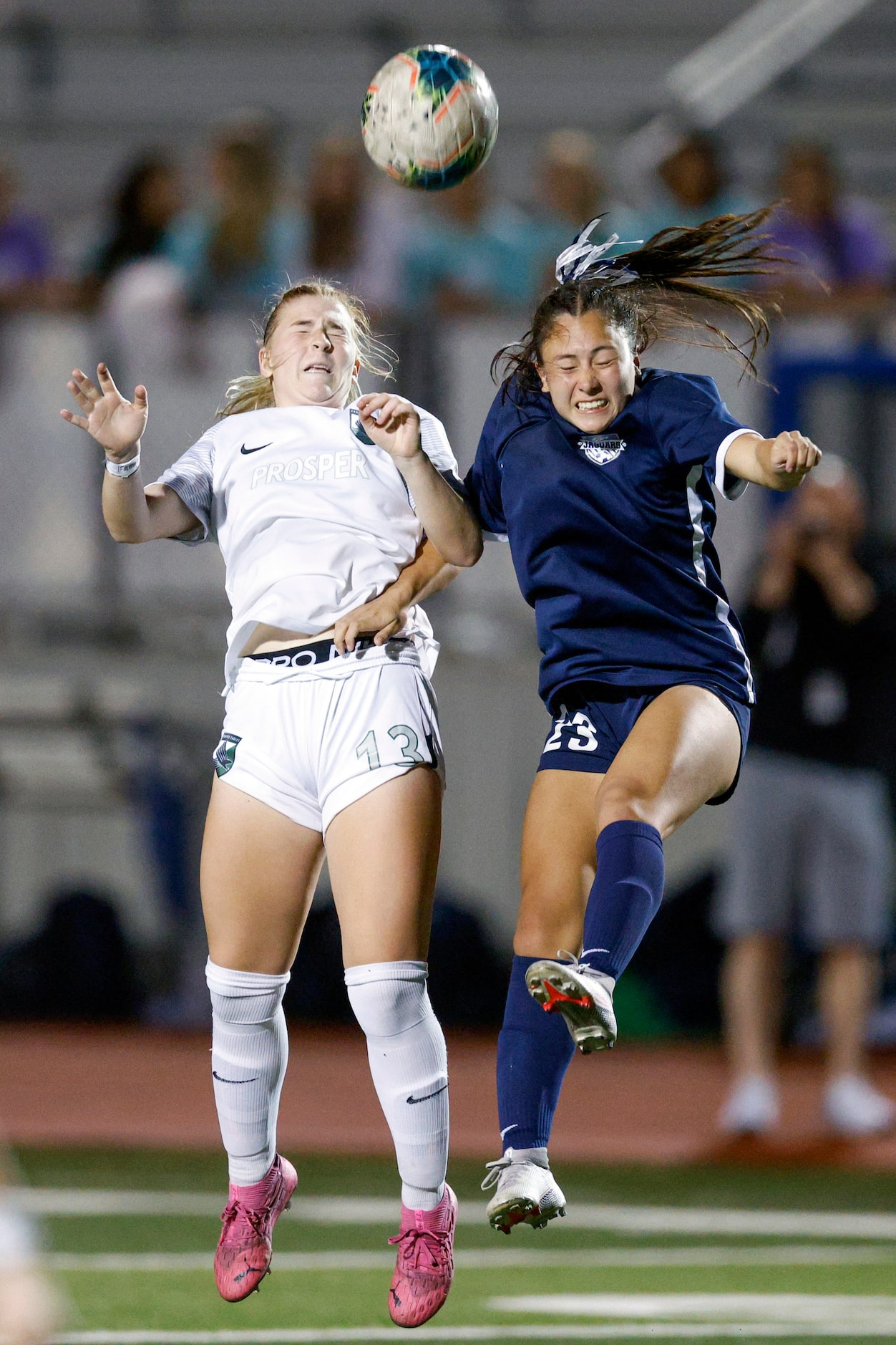 Prosper midfielder Sam Cortez (13) and Flower Mound Emma Hoang (23) jump to head the ball...