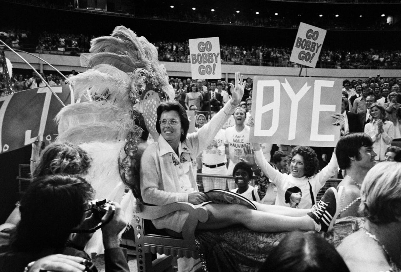 Billie Jean King waves to crowds at the Astrodome in Houston, Texas, as she is borne onto...