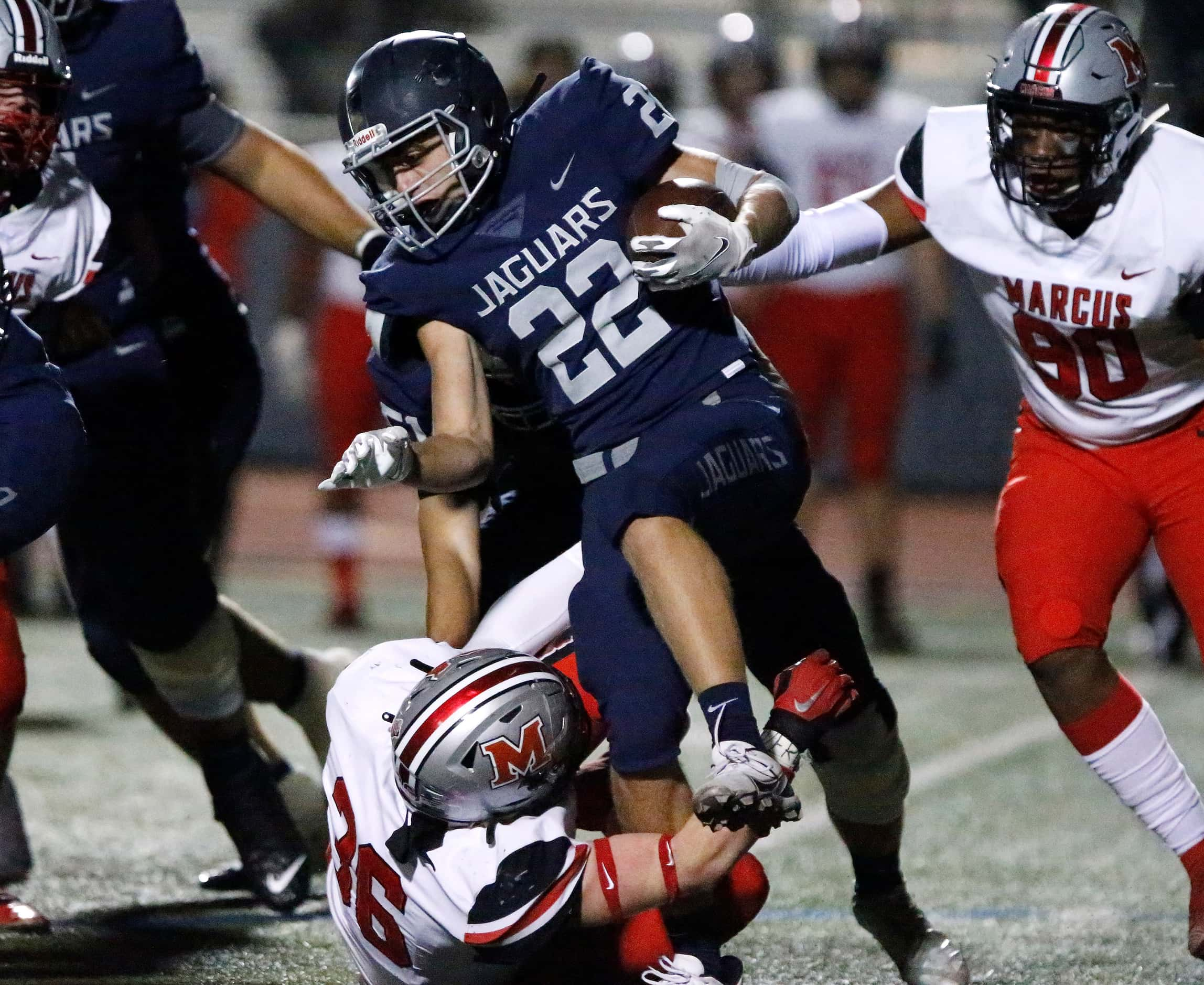 Flower Mound High School running back DJ Conne (22) looks for room to run past Flower Mound...