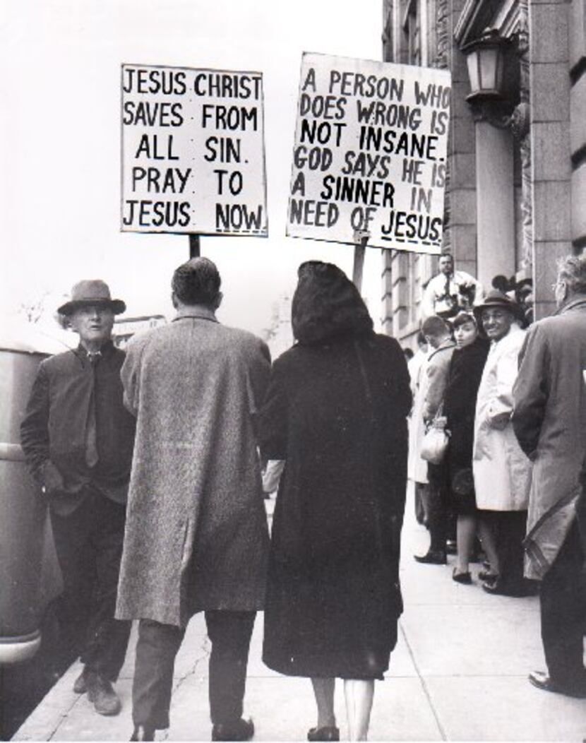 Picket signs carried by evangelist Edwin Tiemann and his wife bear placards decrying the use...